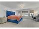 Bright main bedroom with plush carpeting, large windows, and a stylish upholstered bed at 7180 Grace Estate Ave, Las Vegas, NV 89113