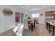 Bright dining area with a sliding glass door to the patio, a modern table set, and a breakfast bar at 7707 W Diablo Dr, Las Vegas, NV 89113