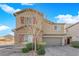 Charming two-story home boasts a stone facade, neutral paint, red shutters, desert landscaping, and a paver driveway at 7707 W Diablo Dr, Las Vegas, NV 89113