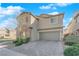 Charming two-story home boasts a neutral paint, desert landscaping, and a paver driveway leading to a two-car garage at 7707 W Diablo Dr, Las Vegas, NV 89113