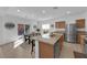 Well-equipped kitchen featuring granite countertops, stainless steel appliances, a breakfast bar, and backyard access at 7707 W Diablo Dr, Las Vegas, NV 89113