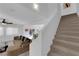 Bright living room with a staircase, cozy seating, and access to the dining area and outdoor space at 7707 W Diablo Dr, Las Vegas, NV 89113