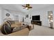 Bright and spacious living room with plush carpet, a ceiling fan, and seamless flow to the upper levels at 7707 W Diablo Dr, Las Vegas, NV 89113