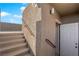 Exterior stairs featuring handrails lead to a door that enters into the house at 7707 W Diablo Dr, Las Vegas, NV 89113