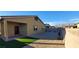 The backyard features rock landscaping with a patch of grass, and the home's exterior with a mountain view at 7910 Shimmery St, North Las Vegas, NV 89084