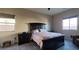 Bedroom featuring a wooden bed frame, neutral carpeting, and window for plenty of natural light at 7910 Shimmery St, North Las Vegas, NV 89084