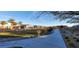 Community park showcasing a pathway, grassy areas, palm trees, and manicured landscaping at 7910 Shimmery St, North Las Vegas, NV 89084