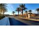 Community entrance sign nestled among mature palm trees and manicured landscaping at 7910 Shimmery St, North Las Vegas, NV 89084