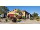 Charming single-story home with well-manicured landscaping, red garage door, and inviting curb appeal at 7910 Shimmery St, North Las Vegas, NV 89084
