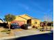 Beautiful home with a red garage door, desert landscaping, and two cars parked out front at 7910 Shimmery St, North Las Vegas, NV 89084