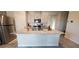 Kitchen featuring a large island with a granite countertop, stainless appliances, and gray cabinets at 7910 Shimmery St, North Las Vegas, NV 89084