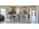Open-concept kitchen and dining area boasts modern finishes and seamless flow to the home's entrance at 7910 Shimmery St, North Las Vegas, NV 89084