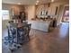 Open-concept kitchen with gray cabinets, granite countertops, stainless steel appliances, and dining table at 7910 Shimmery St, North Las Vegas, NV 89084