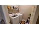 Bright laundry room with modern washer and dryer, and shelving for storage and accessories at 7910 Shimmery St, North Las Vegas, NV 89084