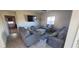 Comfortable living room with cozy seating, a large window, and a wall-mounted TV at 7910 Shimmery St, North Las Vegas, NV 89084