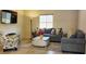 Inviting living room with plush sofas, accent pillows, and a decorative floor lamp for added charm at 7910 Shimmery St, North Las Vegas, NV 89084
