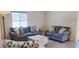 Cozy living room showcases two comfortable sofas, a stylish coffee table, and ample natural light at 7910 Shimmery St, North Las Vegas, NV 89084