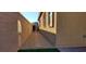 Property side yard with gravel, block wall, and gate access at 7910 Shimmery St, North Las Vegas, NV 89084