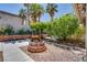 Backyard featuring a brick fire pit, bench along the wall, and a covered area at 7917 Sally Irene Ct, Las Vegas, NV 89113