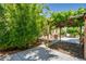 Backyard featuring a covered area, pomegranate tree, and walkway leading to the brick firepit at 7917 Sally Irene Ct, Las Vegas, NV 89113