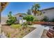 Backyard featuring a shed, trees and plants, roses along the wall, and a concrete walkway at 7917 Sally Irene Ct, Las Vegas, NV 89113