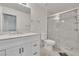 Bright bathroom featuring white cabinets, marble countertop, glass enclosed shower, and white toilet at 7917 Sally Irene Ct, Las Vegas, NV 89113