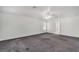 Bedroom featuring gray carpet, a ceiling fan, and an ensuite bathroom at 7917 Sally Irene Ct, Las Vegas, NV 89113