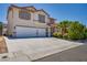 Attractive two-story home with a three-car garage, desert landscaping, and a well-maintained lawn at 7917 Sally Irene Ct, Las Vegas, NV 89113