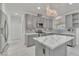 This modern kitchen features marble countertops, stainless steel appliances, and contemporary gray cabinetry at 7917 Sally Irene Ct, Las Vegas, NV 89113