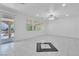 Well-lit living room featuring tile floors, ceiling fan, and access to the backyard patio at 7917 Sally Irene Ct, Las Vegas, NV 89113