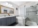 Modern bathroom featuring double sinks, a soaking tub, and a glass-enclosed shower at 792 Valley Rise Dr, Henderson, NV 89052