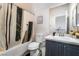 Bathroom featuring a shower-tub combo with stylish shower curtain and vanity at 792 Valley Rise Dr, Henderson, NV 89052