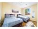 Bedroom with two beds, wood floors, natural light and a decorative art piece at 792 Valley Rise Dr, Henderson, NV 89052