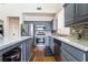 Spacious kitchen features stainless steel appliances, gray cabinetry, stone countertops, and mosaic tile backsplash at 792 Valley Rise Dr, Henderson, NV 89052