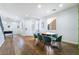 Open-concept space with hardwood floors, a dining table, and a green accent wall at 792 Valley Rise Dr, Henderson, NV 89052