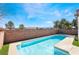 Backyard features a sparkling pool with desert landscaping and a privacy fence at 792 Valley Rise Dr, Henderson, NV 89052