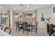 Bright dining room featuring a dark wood table, tile flooring, and sliding glass doors for natural light at 796 Keys View Ave, Las Vegas, NV 89138