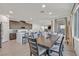 Modern dining area featuring a large wood table, stylish chairs, and ample natural light at 796 Keys View Ave, Las Vegas, NV 89138