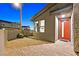 Charming home exterior featuring a red front door and paved entryway at twilight at 796 Keys View Ave, Las Vegas, NV 89138