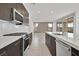 Well-equipped kitchen featuring a modern gas range, stainless steel appliances, and island sink at 796 Keys View Ave, Las Vegas, NV 89138