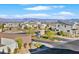 Elevated view of a modern residential street with well-maintained landscaping and a distant city skyline at 796 Keys View Ave, Las Vegas, NV 89138