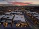 Panoramic aerial shot of a modern community with stunning city and mountain views at twilight at 801 Dragons Eye Dr, Henderson, NV 89012