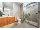 Modern bathroom with glass shower enclosure, sleek vanity, and gray tile flooring at 801 Dragons Eye Dr, Henderson, NV 89012