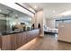 Sleek bathroom with double sinks, modern wood cabinetry, and access to bedroom at 801 Dragons Eye Dr, Henderson, NV 89012