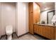 Modern powder bathroom featuring wood cabinets and a sleek vessel sink at 801 Dragons Eye Dr, Henderson, NV 89012