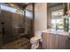 Modern bathroom with a glass-enclosed shower and a stylish wood grain vanity at 801 Dragons Eye Dr, Henderson, NV 89012