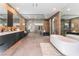 Modern bathroom features a sleek vanity, soaking tub, and a spacious glass-enclosed shower with bench at 801 Dragons Eye Dr, Henderson, NV 89012