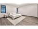 Relaxing main bedroom with wood floors, a soft rug, a bed, and natural light at 801 Dragons Eye Dr, Henderson, NV 89012