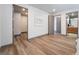 Spacious bedroom featuring wood floors, neutral walls, modern art, and access to ensuite and walk-in closet at 801 Dragons Eye Dr, Henderson, NV 89012