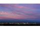 Spectacular city skyline view against a pink, purple, and blue sunset at 801 Dragons Eye Dr, Henderson, NV 89012